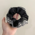Lace scrunchie in black and white checkered pattern shown on hand with beige background - Q699-1 Black Plaid Patchwork