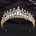 Detail of vintage gold crown with light blue teardrop stones on black satin - H1130 KC Gold + Green Opal