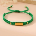 Detail of adjustable green woven rope bracelet with gold metal plaque and sliding knot - Green (Gold Plate)