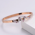 Close-up of 18K rose gold snake-shaped bracelet with pave crystals and hinge detail - Rose Gold
