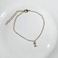 Gold plated bracelet featuring a letter I pendant with zircons on a white plate - Letter I
