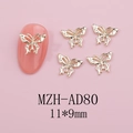 Detail view of golden hollow butterfly nail art charms measuring 11x9mm on pink nail - Gold 3D Hollow Butterfly (AD80)