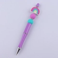 Detail of DIY beadable pen with purple glitter body and colorful rainbow silicone topper - Purple