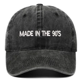 Close-up of MADE IN THE 90'S white embroidery on dark gray washed cotton baseball cap - Black