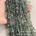 Strands of green phantom quartz beads featuring natural inclusions and polished finish - Green K9 Synthetic Beads