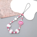 Detail of pink and white beaded phone strap with plush balls and pixel heart pendant - Rose Red