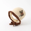 Detailed knit texture of beige infant bonnet with brown fleece trim and bow accent - Approx. 3-6 Years / Beige