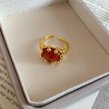 Macro detail of red oval stone set in gold lava textured adjustable ring band - Oval Open Ring / Agate Orange/Real Gold Plated