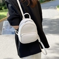 Minimalist white leather mini backpack for women featuring silver zippers and logo detail - Off White