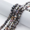 Macro view of 8mm faceted dark grey crystal beads with iridescent coating for jewelry - Rose Red Half Black