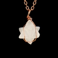 Macro shot of clear crystal Merkaba Star pendant with copper wire wrapping on black background - Antique Copper + Clear Quartz
