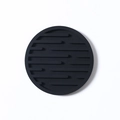 Thick round black silicone coaster with non-slip grooved texture for table protection - Drain Style / Black