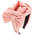 Pink waffle fabric headband with oversized 3D flower and bow on a clean white background - Pink