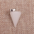Macro view of a conical pink quartz crystal pendant on rustic burlap fabric background - White Jade
