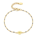 Close-up of golden stainless steel eye bracelet with grey enamel beads and lobster clasp - Gray