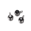 Detail of three stainless steel round pendants with black faceted zircon stones - 10 Pieces per Pack / Steel Border Black Stone
