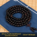 Macro detail of 108 African Blackwood prayer beads on a blue fabric background - Standard 8mm*108 Beads