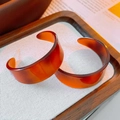 Macro shot of retro amber tortoiseshell resin C-shaped earrings on a fabric tray - Amber Tortoiseshell Resin C-Shape Style (12#)