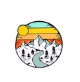 Artistic round enamel landscape pin featuring snowy mountains and a golden sun - Nature Landscape River