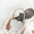 Detail of heart-shaped evening bag featuring white pearls and silver rhinestones on a magazine - Mini / Silver Pearl Water Drop
