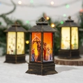 Close-up of vintage bronze Christmas lanterns with warm LED Nativity scene graphics - Starry Small Church / Gold
