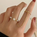 Punk style gold double ring with white pearls and long chain on model fingers - Artificial Pearl Style / Silver
