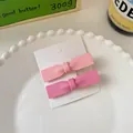 Sweet matte pink bow hair clips set on white display card inside a ceramic dish - Large Bow Clip Style (1050B)