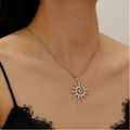 Close-up of silver hollow sun pendant necklace with spiral pattern on a female model - Steel Color Swirl Sun Necklace (5674)
