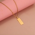 Detailed close-up of a gold rectangle pendant with box chain on a soft pink display - Gold Color (12*29mm)(MP564)