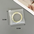 Detailed view of an 11x11cm thickened EVA jewelry storage bag with a round bracelet - 50 Silk Frosted Zipper Bag / 11x11cm