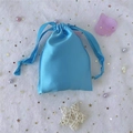 Sky blue satin drawstring bag for cosmetics and gifts shown on starry mesh background - 15.5*11.5 / Sky Blue