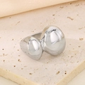 Detail of silver irregular streamlined metal ring with polished finish on travertine stone - US 6 / Silver (Irregular Fluid)