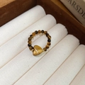 Macro shot of tiger eye beaded ring with heart stone in jewelry box slot - 30# Heart Shape Tiger Eye Elastic Beaded Ring