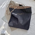 Detail view of retro denim tote bag with colorful beaded handles and brown plaid lining - Light Blue-Brown Strap