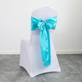 White spandex chair cover with a decorative turquoise satin bow tie for events - Lake Blue