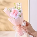 Close-up of hand-knitted pink and white crochet rose bouquet with ribbon bow - Single Knitted Pink White Rose