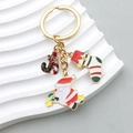 Golden Christmas keychain featuring Santa Claus, stocking, and candy cane charms - Santa Sock Candy Style (ER816)