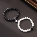Magnetic couple bracelets with black volcanic stone and white pearls on dark surface - Black Lava & White Pearl Style - Heart Magnetic