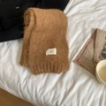 Soft wool blend knit scarf in warm brown folded on bed with a minimalist design - 3g Series / Khaki