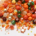 Macro shot of 8mm colorful glass and resin beads in mixed shapes for DIY jewelry making - Orange Yellow Series
