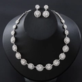 Silver bridal jewelry set featuring a circular cluster necklace and matching earrings - Silver