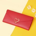 Close-up of red leather long wallet featuring a stylish gold heart-shaped metal buckle - Red