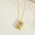 Golden bubble letter R pendant necklace with pavé cubic zirconia on cross chain - Letter R
