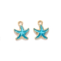 Detail view of blue enamel starfish pendants with gold-plated edges and metal loops - Blue