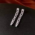 Close-up of silver chain earrings with pavé square zircon drop on a textured background - Silver (Silver Pin)