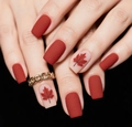 Close-up of matte red and maple leaf patterned short square press-on nails for autumn - Matte Red Maple Art Style (CW771)