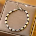 Black and white beaded bracelet with stainless steel lobster clasp and logo tag - Stainless Steel Black White Rice Bead Bracelet (10851)