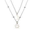 Detail showing silver double-layered necklace with sun and moon pendants on white base - Double Layer Sun Moon / Silver