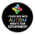 Detailed close-up of a round Autism Awareness pin with colorful puzzle logo on black finish - Style 7 (Teach Kids)