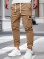 Dettaglio dei pantaloni cargo kaki con grandi tasche laterali e polsini elastici - S / Cachi